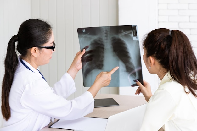 Medical doctor give consultation to patient with xray film