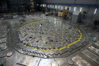 A specialist walks across a nuclear reactor head at the Ignalina nuclear power plant in Visaginas