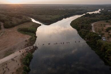 Migrants cross Rio Grande river near Del Rio, Texas