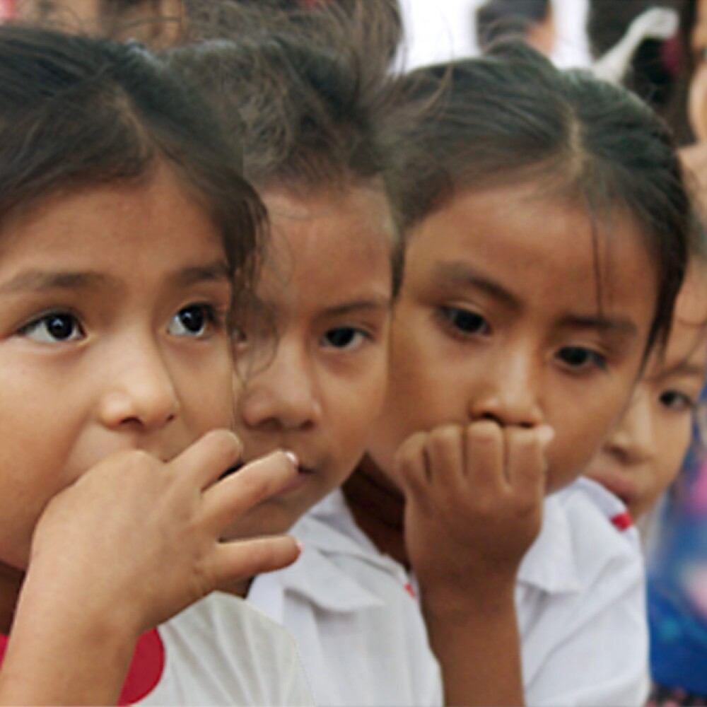 Young students taking chewable mebendazole to help treat intestinal parasites