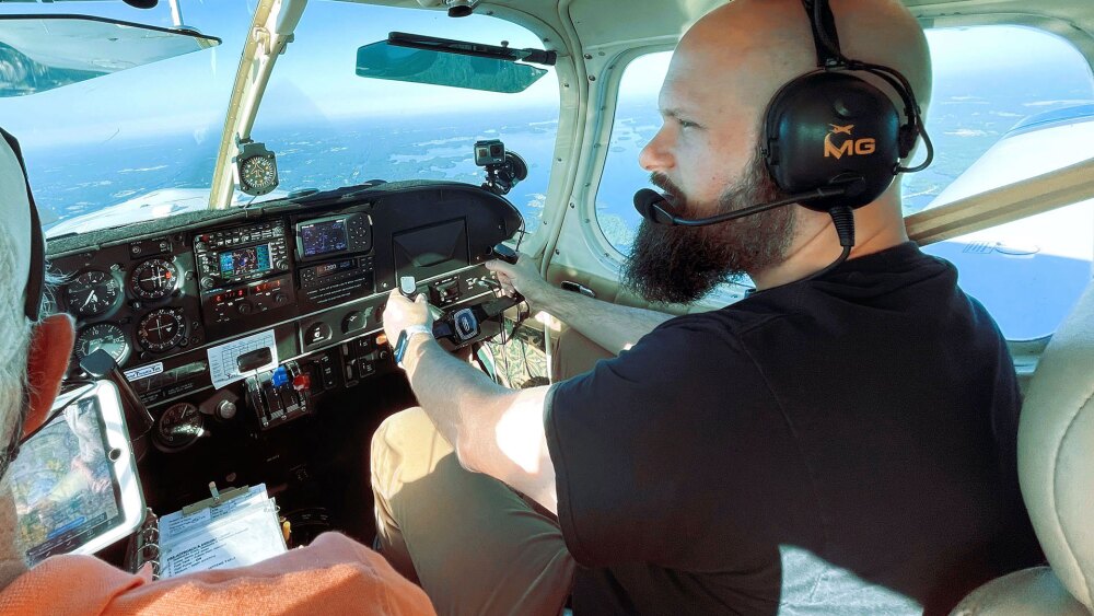 Sam Seavey piloting an aircraft from the cockpit