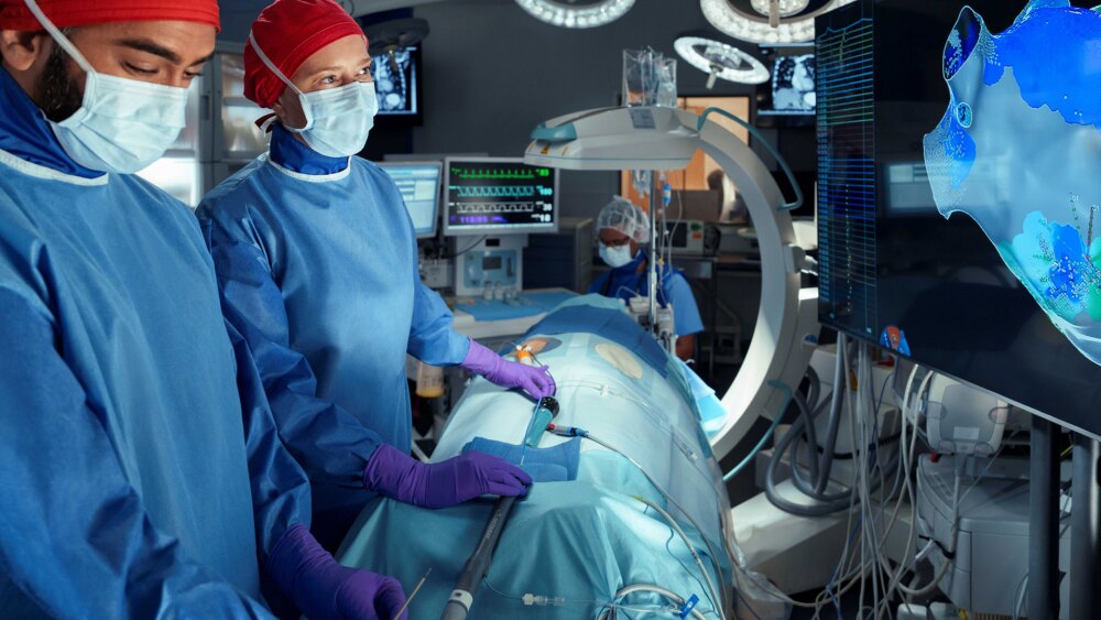 Two cardiac electrophysiologists performing a cardiac ablation procedure to treat AFib