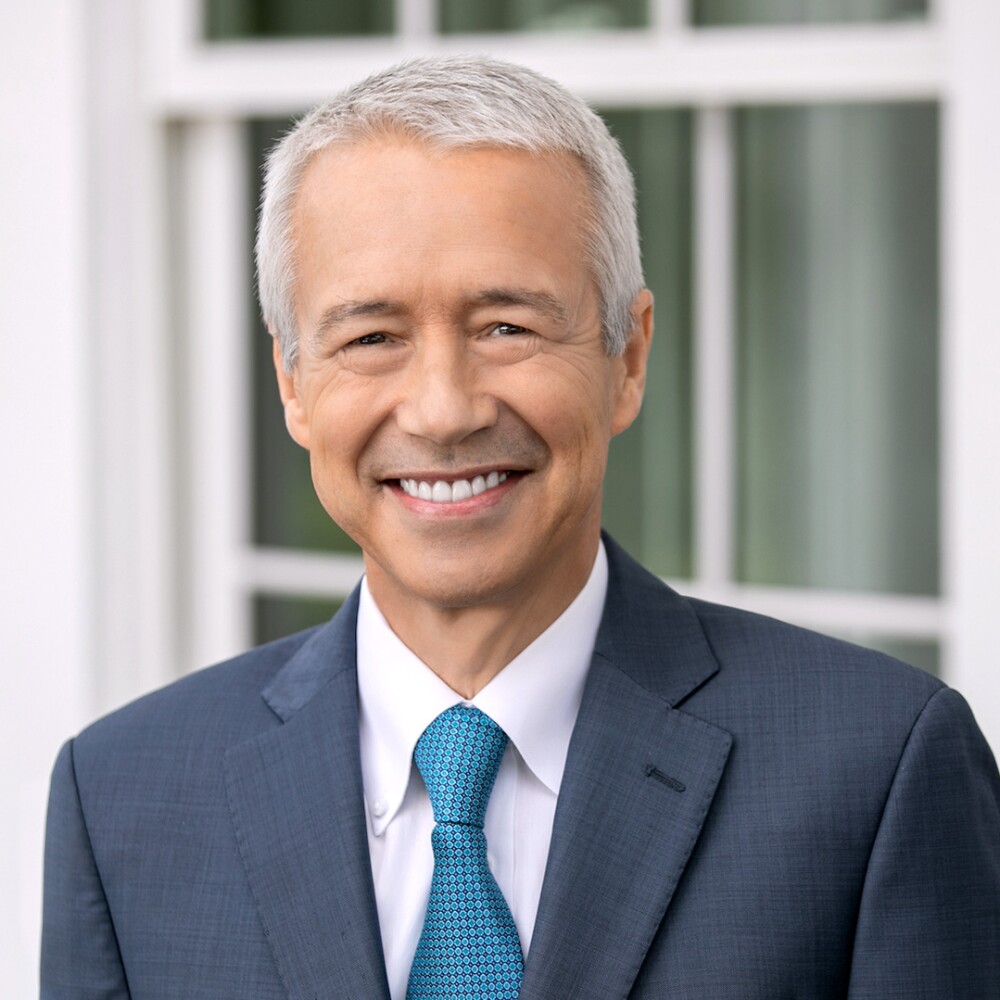 Headshot of Johnson & Johnson's CEO and Chairman of the Board Joaquin Duato wearing a navy blue suit and bright blue tie 