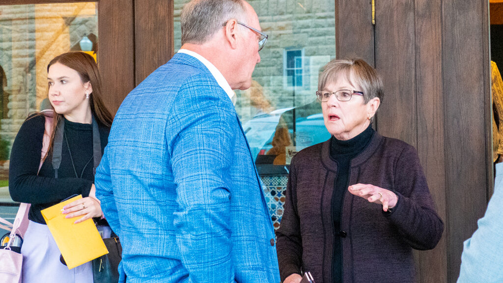 Gov. Laura Kelly talks with Sen. Jeff Longbine during a visit April 25, 2024, to Emporia.