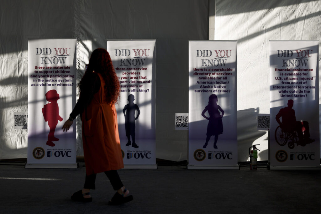 An attendee looks at a series of banners for National Crime Victims’ Rights Week Candlelight Vigil on the National Mall on April 24, 2024, in Washington, D.C.