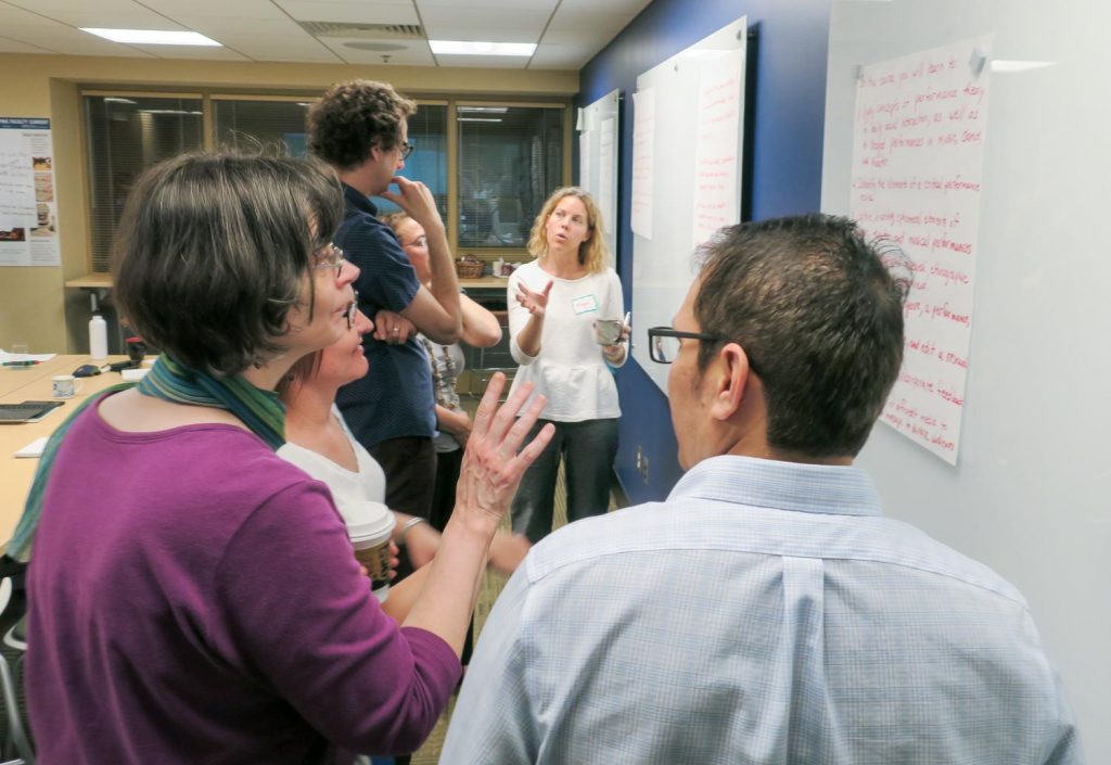 Team discussing at a white board.