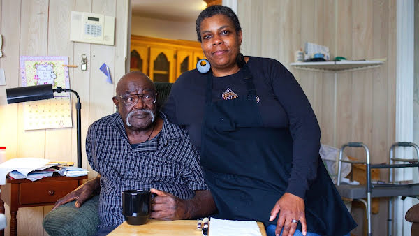 Man and woman posing for camera.