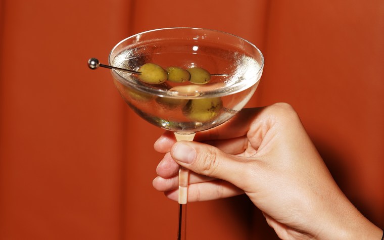 Martini glass cocktail with olives, close-up.  