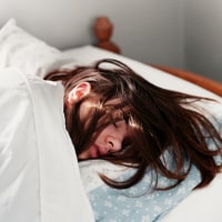 Young woman sleeping in bed