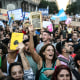 Image: Demonstrators sing the national anthem during a march in protest of the budget adjustment to public universities