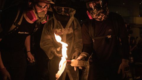 HONG KONG, CHINA - AUGUST 31: Protesters light a molotov cocktail after setting a makeshift barricade on fire  after clashing with police at an anti-government rally on August 31, 2019 in Hong Kong, China. Pro-democracy protesters have continued rallies on the streets of Hong Kong against a controversial extradition bill since 9 June as the city plunged into crisis after waves of demonstrations and several violent clashes. Hong Kong's Chief Executive Carrie Lam apologized for introducing the bill and declared it "dead", however protesters have continued to draw large crowds with demands for Lam's resignation and completely withdraw the bill.  (Photo by Chris McGrath/Getty Images)