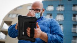 In this Aug. 6. 2020, file photo, Joseph Ortiz, a contact tracer with New York City's Health + Hospitals battling the coronavirus pandemic, uses his tablet to gather information as he heads to a potential patient's home, in New York. Coronavirus contact tracing programs across the U.S. scaled back their ambitions as cases surged in winter, but New York City has leaned into its $600 million tracing initiative. 