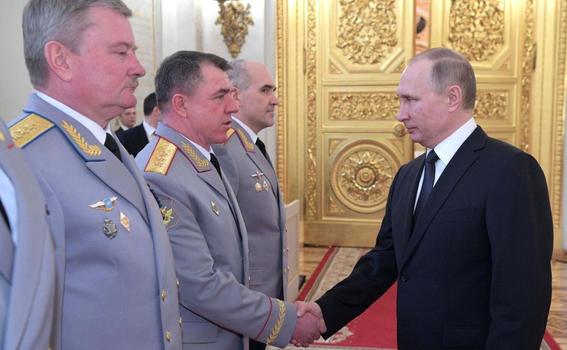 Vladimir Putin shakes hands with  Zhuravlyov at the Kremlin in Moscow on March 23, 2017.