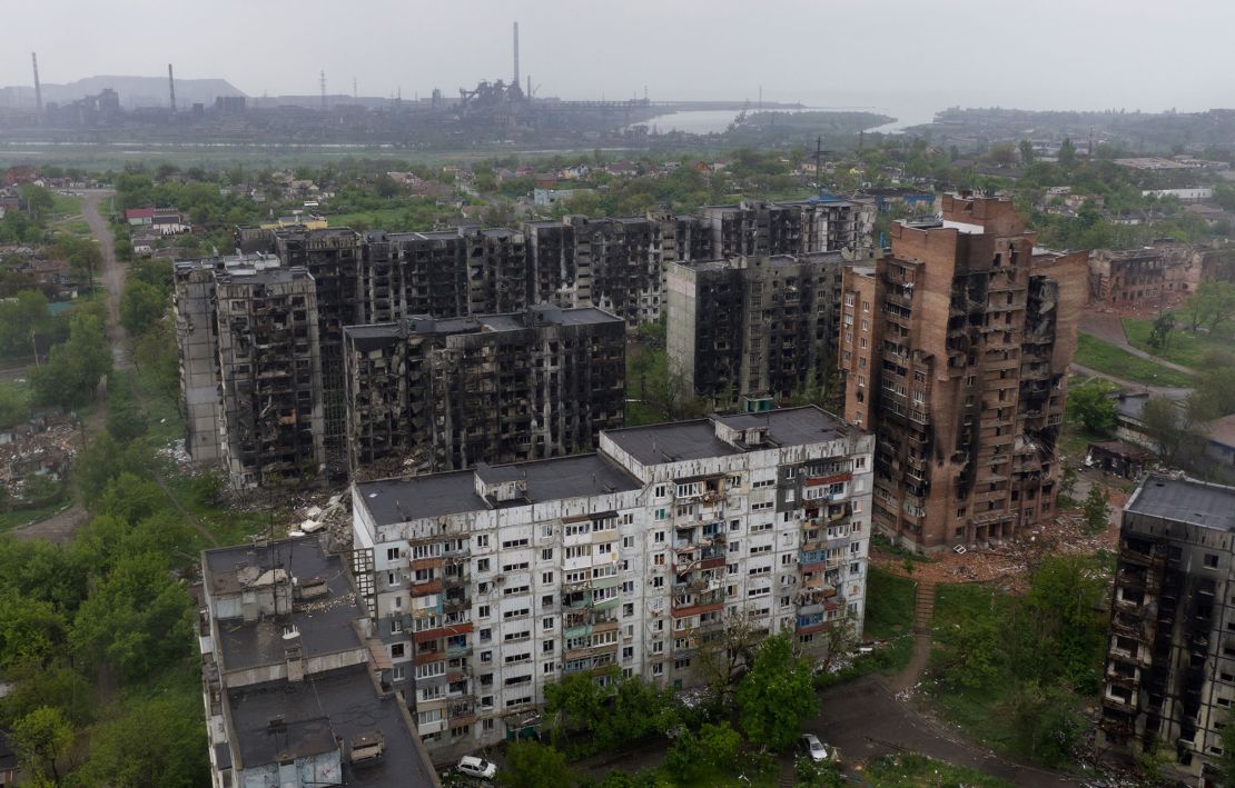 Damaged residential buildings in Mariupol, with the Azovstal steel plant in the background in May 2022. DPR authorities said the three men were captured in the port city by Russian forces in April.