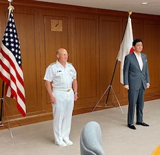 Chief of Naval Operations (CNO) Adm. Mike Gilday stands near Defense Minister Nobuo Kishi in a conference room.