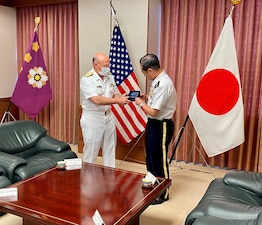 Chief of Naval Operations (CNO) Adm. Mike Gilday exchanges a gift with Japan Chief of Staff of the Joint Staff Gen. Koji Yamazaki at the Japan Ministry of Defense in Tokyo.