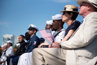 Soldiers, Sailors, Airmen, a Coast Guardsman and an Army veteran, and their guests, listen to remarks during a naturalization ceremony aboard USS Constitution.