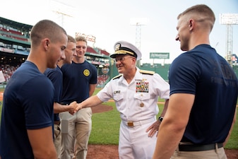 Chief of Naval Operations Adm. Mike Gilday congratulates newly-enlisted Navy Sailors prior to a Red Sox baseball game at Fenway Park, Boston.
