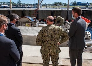 PANAMA CITY, Fla. (Mar– Dr. Peter Adair (far left), technical director at Naval Surface Warfare Center Panama City Division discuss unmanned systems with NSWC PCD engineers Evan McCaw (left), Ricky McNaron (right) , and Adm. Mike Gilday (center), Chief of Naval Operations, March 4 (U.S. Navy Photo by Anthony Powers)