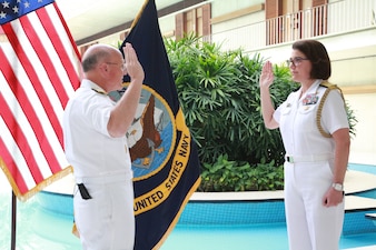 NEW DELHI (Oct. 12, 2021) Chief of Naval Operations (CNO) Adm. Mike Gilday, left, administers the oath of office to Rear Adm. Eileen Laubacher, the U.S. defense attaché for the U.S. Embassy in New Delhi, during Laubacher’s promotion ceremony. Gilday is in India to meet with India Chief of Naval Staff Admiral Karambir Singh and other senior leaders from the Indian Navy and government.  (Photo courtesy of U.S. State Department/Released)