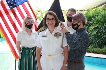 NEW DELHI (Oct. 12, 2021) Rear Adm. Eileen Laubacher, the U.S. defense attaché for the U.S. Embassy in New Delhi, has her new rank pinned on by her family during a promotion ceremony. Laubacher was administered the oath of office by Chief of Naval Operations (CNO) Adm. Mike Gilday. Gilday is in India to meet with India Chief of Naval Staff Admiral Karambir Singh and other senior leaders from the Indian Navy and government. (Photo courtesy of U.S. State Department/Released)