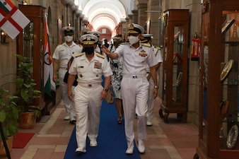 Chief of Naval Operations (CNO) Adm. Mike Gilday, left middle, walks with Chief of Naval Staff, Indian Navy Adm. Karambir Singh, right middle, during a visit to the Secretariat Building in New Delhi. Gilday is in India to meet with Singh and other senior leaders from the Indian Navy and government. (Photo courtesy of U.S. State Department/Released)