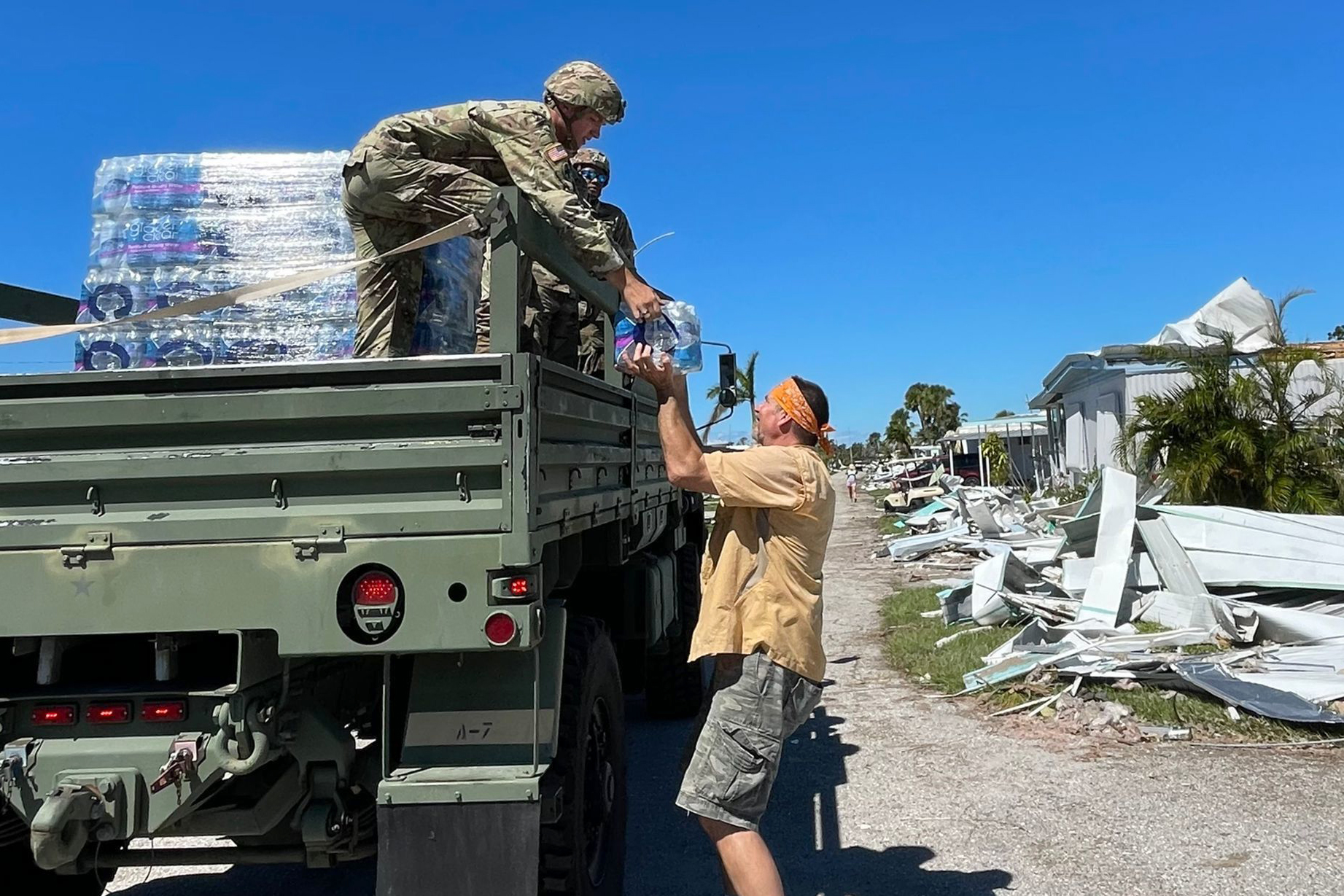 Florida National Guard soldiers deliver food and water to residents of neighborhoods devastated by Hurricane Ian in Port Charlotte, Fla., Oct. 2, 2022.