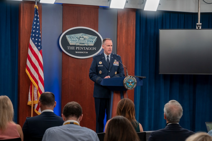 A man speaks to an audience from a podium.