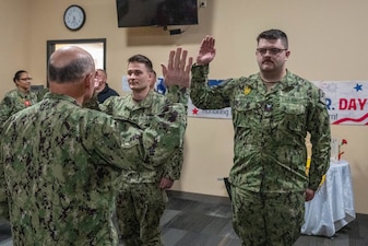 NAVAL SUPPORT FACILITY DEVESELU, Romania (Jan. 19, 2023) - Chief of Naval Operations Adm. Mike Gilday reenlists Sailors assigned to U.S. Aegis Ashore Missile Defense System Romania (AAMDS), during a visit to Naval Support Facility Deveselu, Romania, Jan. 19. AAMDS is under the operational control of the U.S. Naval Forces Europe, based in Naples, Italy, and is part of the European Phased Adapted Approach (EPAA), which protects European NATO allies and U.S. deployed forces in the region. (U.S. Navy photo by Lt. Michael Valania/released)