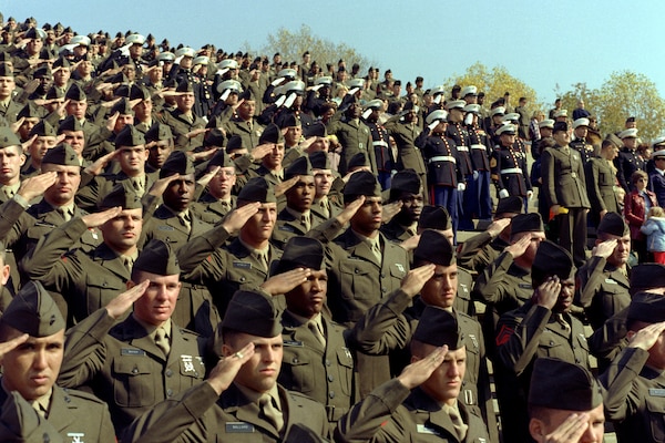 Hundreds of Marines salute during a Marine Corps pageant.