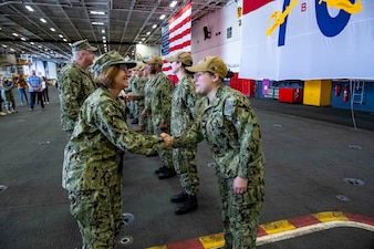 YOKOSUKA, Japan (Nov. 23, 2023) – Chief of Naval Operations Adm. Lisa Franchetti reenlists Sailors aboard the U.S. Navy's only forward-deployed aircraft carrier USS Ronald Reagan (CVN 76), Nov. 23. CNO and Master Chief Petty Officer of the Navy James Honea served Thanksgiving dinner to Sailors and their families aboard the ship during their visit. (U.S. Navy photo by Chief Mass Communication Specialist Amanda R. Gray)