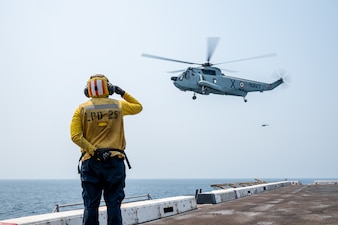 An Indian navy UH-3H Sea King helicopter lifts off from USS Somerset (LPD 25) while underway in the Bay of Bengal.