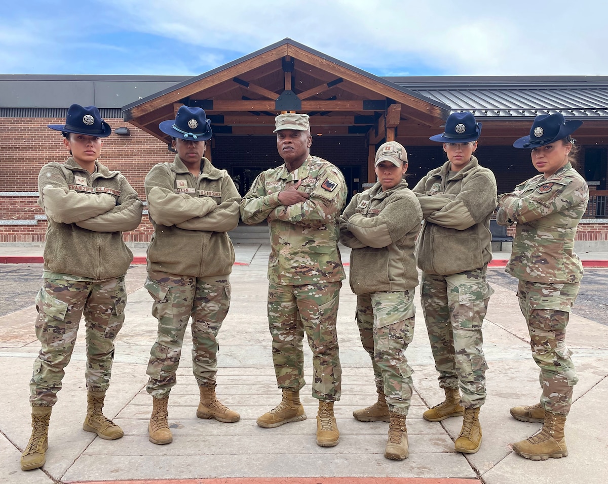 SEA Tony Whitehead, center, senior enlisted advisor to the chief of the National Guard Bureau, poses with military training instructors from the Air Force’s 433rd Training Squadron during the 2024 Women's Air & Space Power Symposium at Peterson Space Force Base, Colorado, March 26, 2024. The symposium addressed military integration, gender diversity, inclusivity and leadership advocacy.