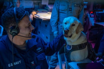 Capt. Demo sits with a sonar technician (surface) aboard USS Mason (DDG 87) in the Red Sea.