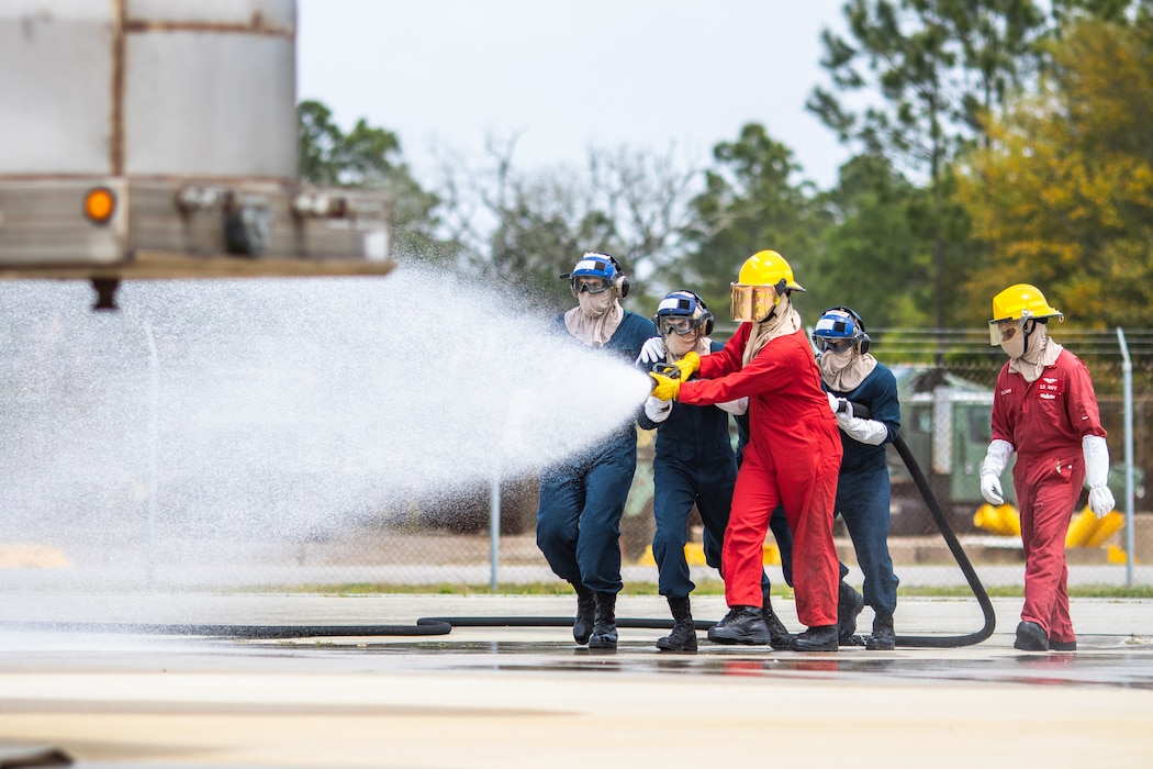 Aviation Boatswain's Mate "A" School students practice aircraft firefighting at Naval Air Station Pensacola.