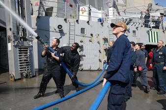 Sailors aboard USS Howard (DDG 83) conduct a freshwater wash down in the north Pacific Ocean.