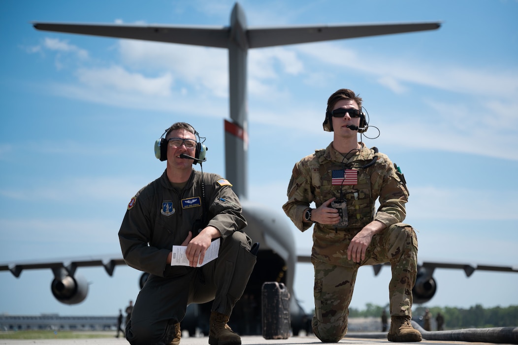 Master Sgt. Greg Barham, 167th Airlift Wing instructor loadmaster, and Staff Sgt. Christian Magliocca, 15th Airlift Squadron instructor loadmaster, await refueling operations