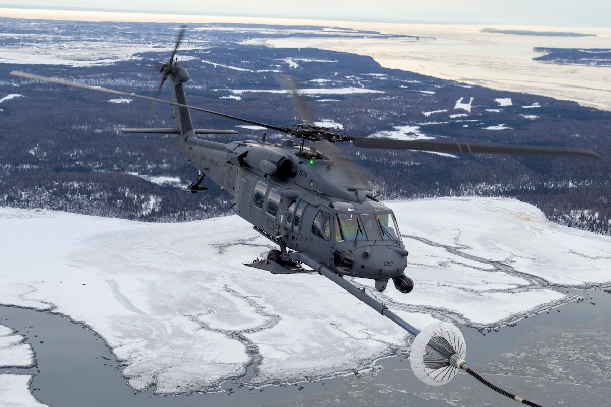 An Alaska National Guard 210th Rescue Squadron HH-60G Pave Hawk refuels with a 211th Rescue Squadron HC-130J Combat King II during a training exercise. A 210th Pave Hawk required air-to-air refueling during a Jan. 15, 2024, rescue of a snowmachiner near Valdez.