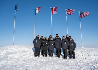 240316-N-EI510-1591 BEAUFORT SEA, Arctic Circle (March 16, 2024) – Chief of Naval Operations Adm. Lisa Franchetti, poses for a photo with other distinguished visitors at Ice Camp Whale during Operation Ice Camp (ICE CAMP) 2024. ICE CAMP is a three-week operation that allows the Navy to assess its operational readiness in the Arctic, increase experience in the region, advance understanding of the Arctic environment, and continue to develop relationships with other services, allies, and partner organizations. (U.S. Navy photo by Mass Communication Specialist 1st class Scott Barnes)