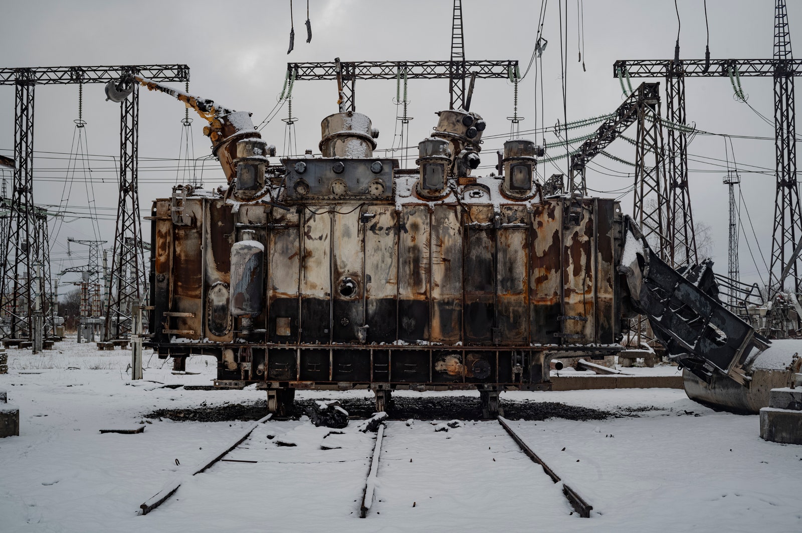 Part of a highvoltage transformer covered in snow.