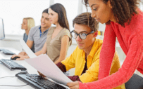 five people around a desk