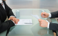 Men interviewing at table