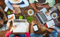 four people sitting around table