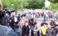 cameraman filming a crowd of people