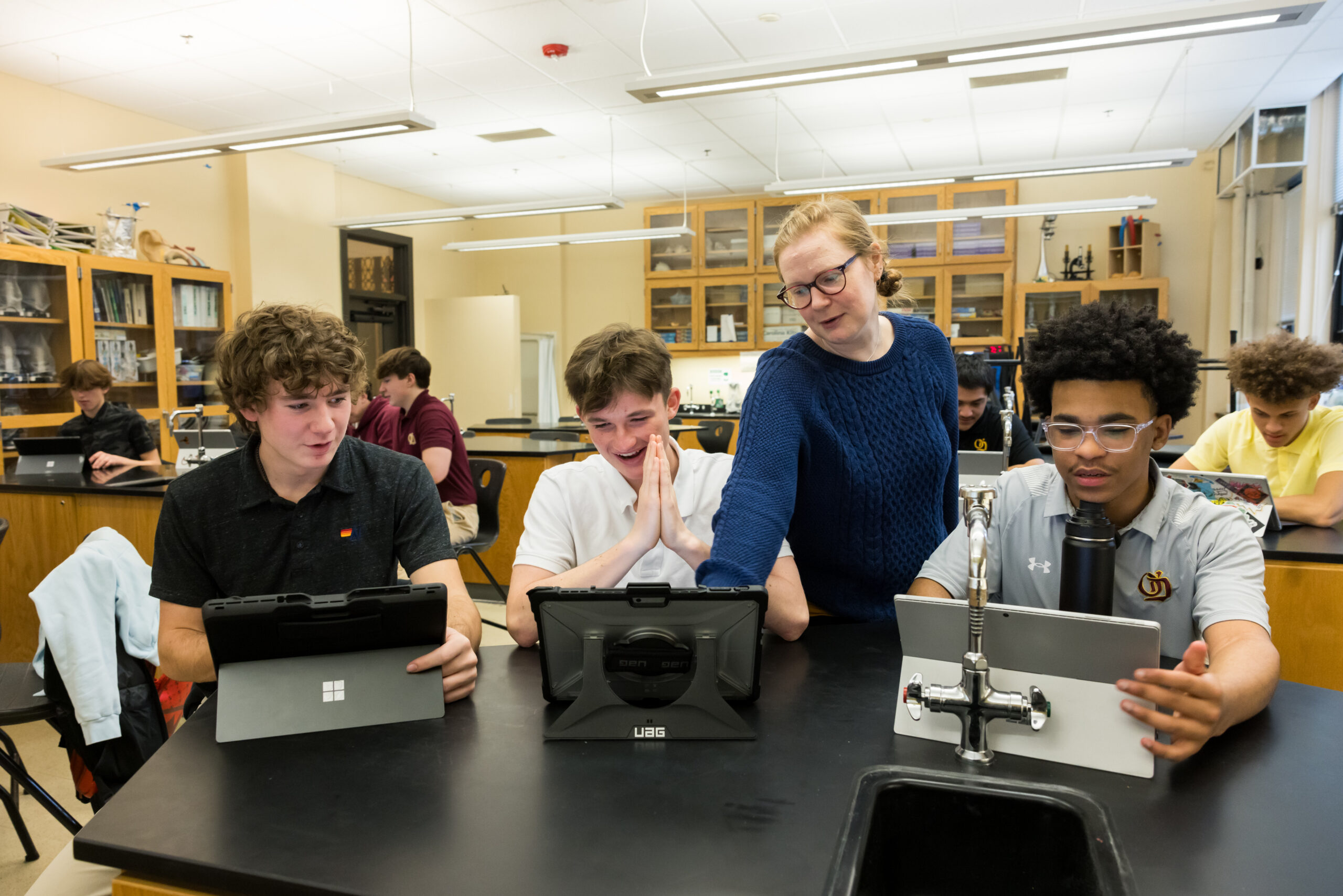 O'Dea High School teacher Clare Prowse and students with laptops.