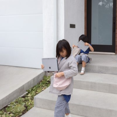 Two girls slide their Surface Go's into bags