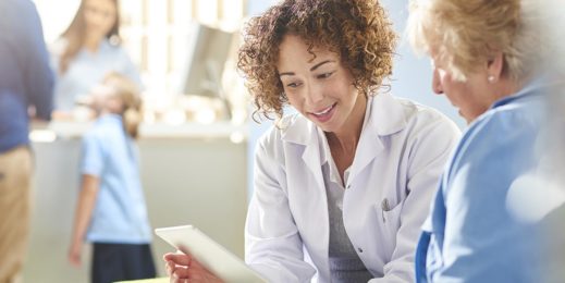 Medical professional uses a mobile device to consult with a patient