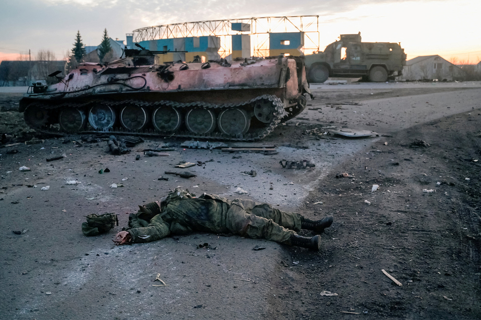 The body of a soldier, without insignia, who the Ukrainian military claim is a Russian army serviceman killed in fighting, lies on a road outside the city of Kharkiv