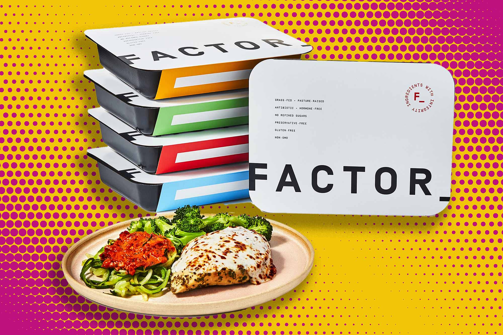 A stack of Factor meals on an orange and pink polkadot background