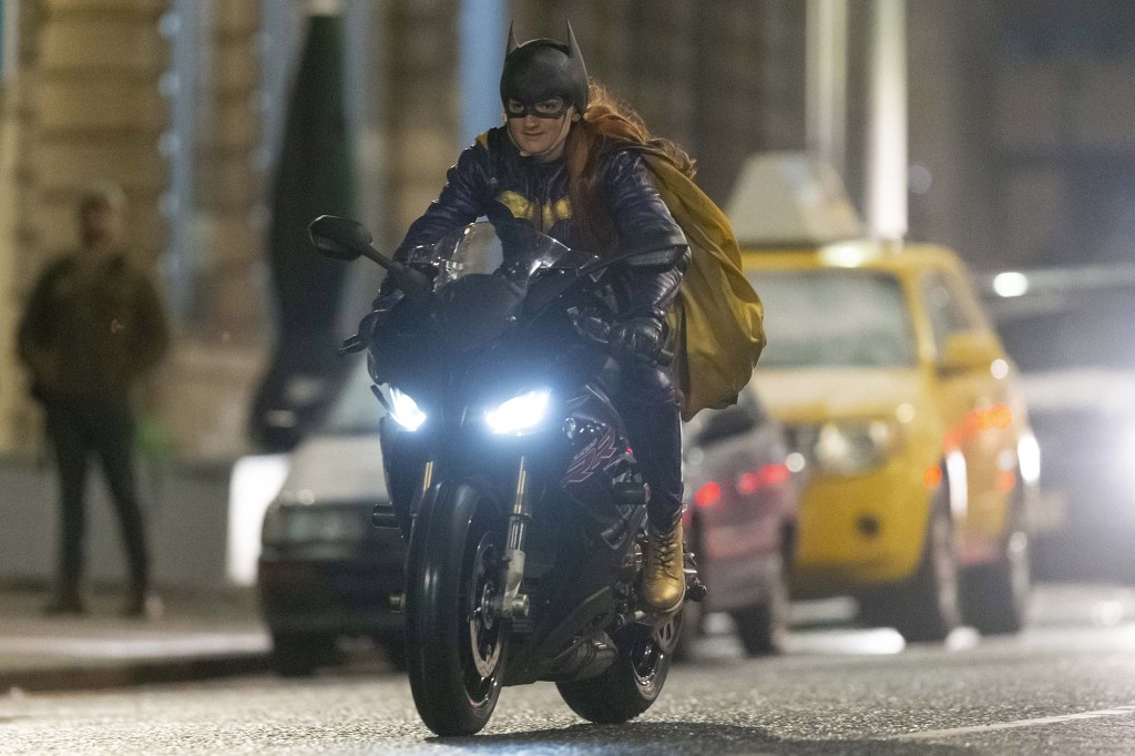 Leslie Grace's stunt double dramatically rides through the streets.